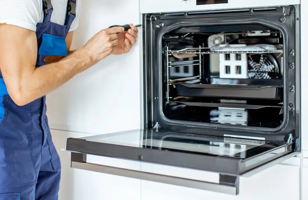 Engineer repairing an electric oven 